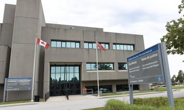 The exterior of Milton courthouse flags and signage.
