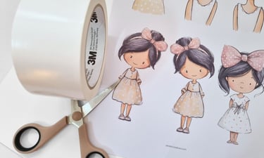 Printed sheet with cute girl illustrations and scissors on it