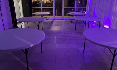 Empty venue with six round tables