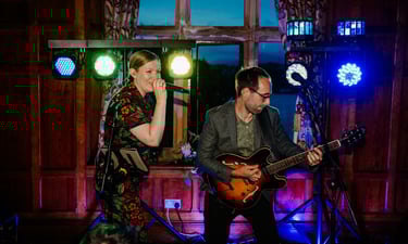 a man and woman playing guitar together