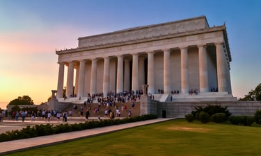 Iconic Lincoln Memorial at sunset in Washington DC, featuring crowds on the grand white marble steps.