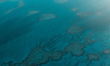 a plane flying ove of water