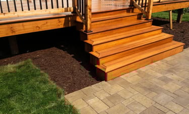 Escalier de terrasse en bois sur mesure avec transition vers pavés par M2 Paysage