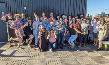 a group of people at the Portland Design Thinkers rooftop happy hour, posing and making silly faces