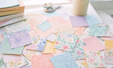 pastel patterned papers on the craft table. Creative, crafty vibe.