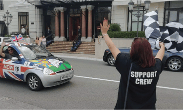 a woman waving a flag in a car