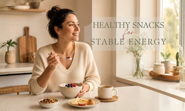 Woman enjoying a healthy snack with Greek yogurt, berries, nuts, and herbal tea at a kitchen table.