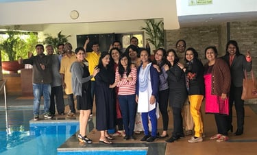 a group of people standing around a pool