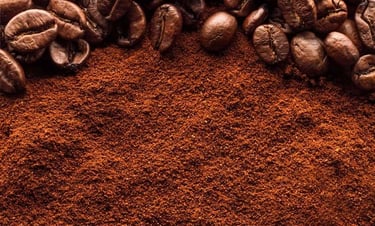 a pile of coffee powder and coffee beans