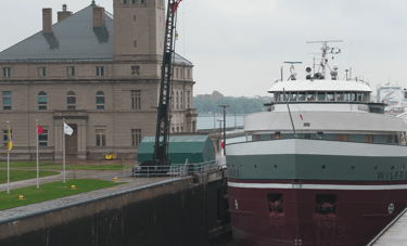 Classic forward pilothouse freighter Wilfred Sykes eases into the MacArthur Lock.