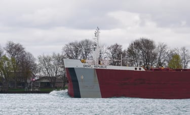 The bow section of the freighter Great Republic. A red ship with black and gray bow stripes.