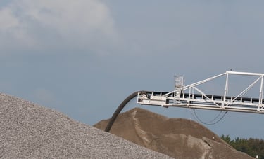 A close-up view of stone coming off the end of a self-unloading boom.