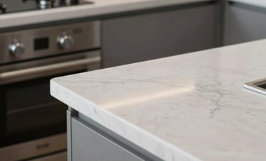 Close-up architectural photography of a spotless Australian kitchen. Polished white stone countertops reflecting soft light. Stainless steel appliances with no fingerprints. Minimalist style.