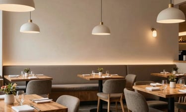 A wide shot of a sophisticated, cozy restaurant interior in North America, featuring scandinavian design elements, warm wooden tables, and crisp parchment colored walls.