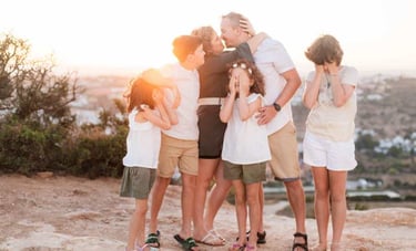 a family of four children and their parents in a family photo