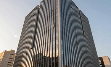 A sleek, modern corporate office building in a Brazilian urban setting during golden hour, reflecting trust and stability. Wide angle shot, clean architectural lines, sophisticated atmosphere.