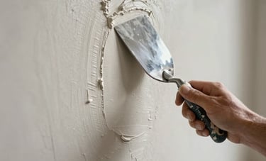 A detailed close-up shot of a professional at work in a Northern European home, applying high-quality stucco to a wall. The focus is on the smooth, precise texture of the plaster and the skilled hand holding a steel trowel. The lighting is soft and natural, emphasizing the meticulous attention to detail and high finish level.