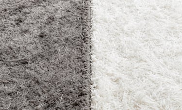 A split-screen comparison of a carpet before and after deep cleaning. One side is a dull, dirty grey, while the other side is a bright, pristine white, showcasing powerful restoration.