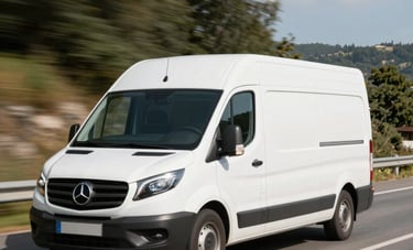 A white delivery van driving through a scenic, sunlit road in Western Europe. The image conveys speed, reliability, and modern logistics through a clean and bright photographic style.