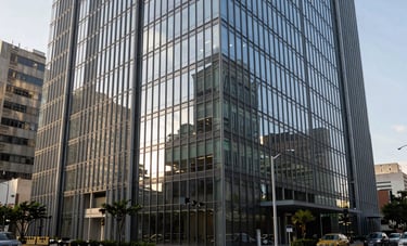 Modern office building exterior with glass facade in a Latin American business center, sharp focus, professional photography, clean urban environment.