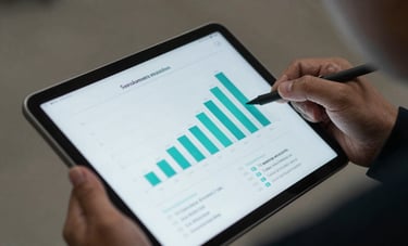 A close-up photograph of a digital tablet showing social media growth charts, being held by someone in professional Southeast Asian / Indonesian business attire, sharp focus, vibrant teal tones.