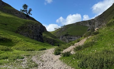 Mentoring in nature. Image of the peak district, rolling green hills and a rocky winding path.