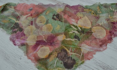 Handmade leaves print silk scarf with botanical leaf impressions in pink, green, and yellow tones.