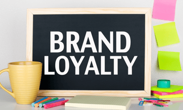 a blackboard with a cup of coffee and a mug of coffee and it says "brand loyalty "