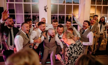Groom and groomsmen having fun at wedding party