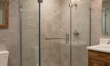 A modern, warm North American bathroom remodel with a glass-enclosed walk-in shower, elegant grey-beige tiling, and natural wood accents. Soft, warm lighting creates an inviting atmosphere of high-quality craftsmanship.