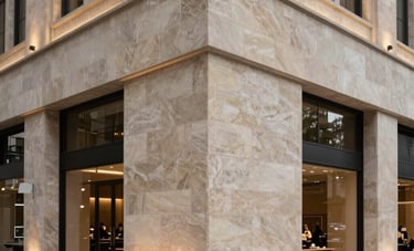 Interior of a sophisticated South American / Brazilian modern commercial building showing a high-end stone facade installation. Architectural lighting, precise alignment of materials, clean and modern aesthetic, professional photography.