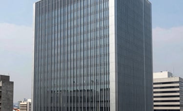 Modern corporate architecture of a business center in a South American metropolis, symbolizing stability and authority. Wide shot, clean lines, steel blue and light grey tones.
