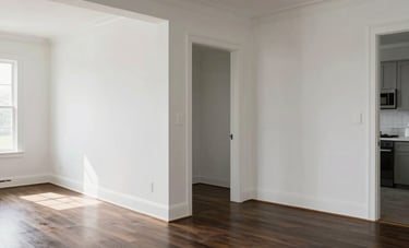 An expansive North American open-concept living area following a full interior renovation, with dark hardwood floors, freshly painted cloud white walls, and high-quality custom finishes that project professionalism.