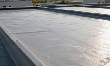 A wide-angle shot of a perfectly finished torchdown flat roof on a modern North American / US commercial building. The surface is clean and uniform, reflecting professional maintenance and quality craftsmanship under a bright sky.