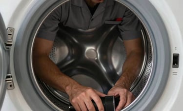 A detailed shot of a washing machine's internal drum being serviced by a professional in a slate gray uniform. The setting is a clean laundry area in a Middle Eastern home, shot with a professional, sharp focus.