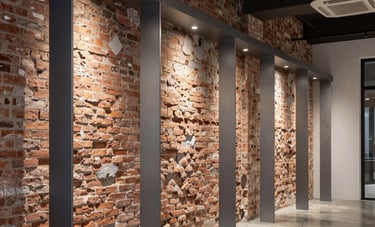Photography of a contemporary boutique or local business interior in Barcelona, showcasing renovated industrial-style brick walls, modern steel gray lighting fixtures, and polished concrete floors.
