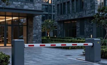 A sleek, modern automated boom barrier at the entrance of a contemporary South Asian corporate park. The scene is shot at dusk with slate grey architecture and professional lighting in deep blue tones.