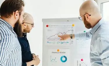 Business professionals reviewing data for market adaptation and localization strategy