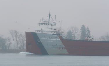 Close-up of the forward pilothouse of classic freighter Arthur M. Anderson passing in the fog.
