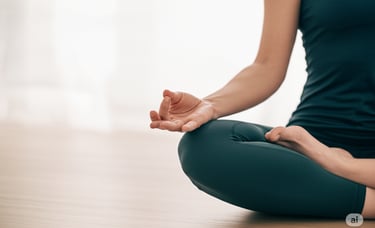 a woman sitting in a yoga pose