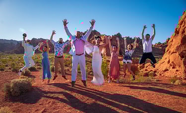 a group of people standing in a desert