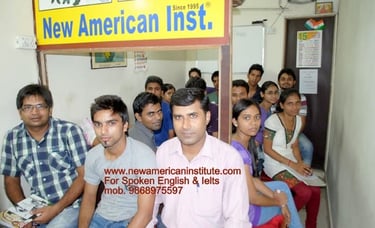 a man sitting in front of a sign that says new american institute