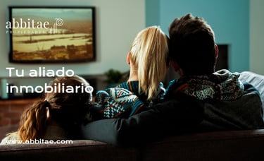 Un hombre y una mujer sentados en un sofá viendo la televisión.