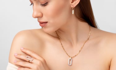 a woman with a necklace and a necklace with a ring