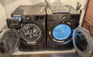 LG washer on the left while LG dryer on the right both doors are open