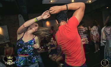 a man and woman dancing at a party