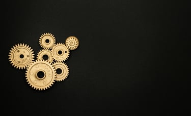 wheels representing thinking and innovation, revealed behind a red theatre curtain