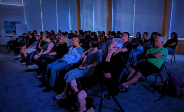 Audience immersed in a movie screening hosted by the Auckland International Film Club.