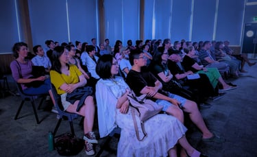 Diverse audience enjoying a cozy film screening at Auckland International Film Club.