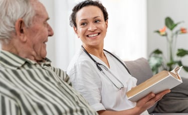 Healthcare worker smiling at an elderly patient